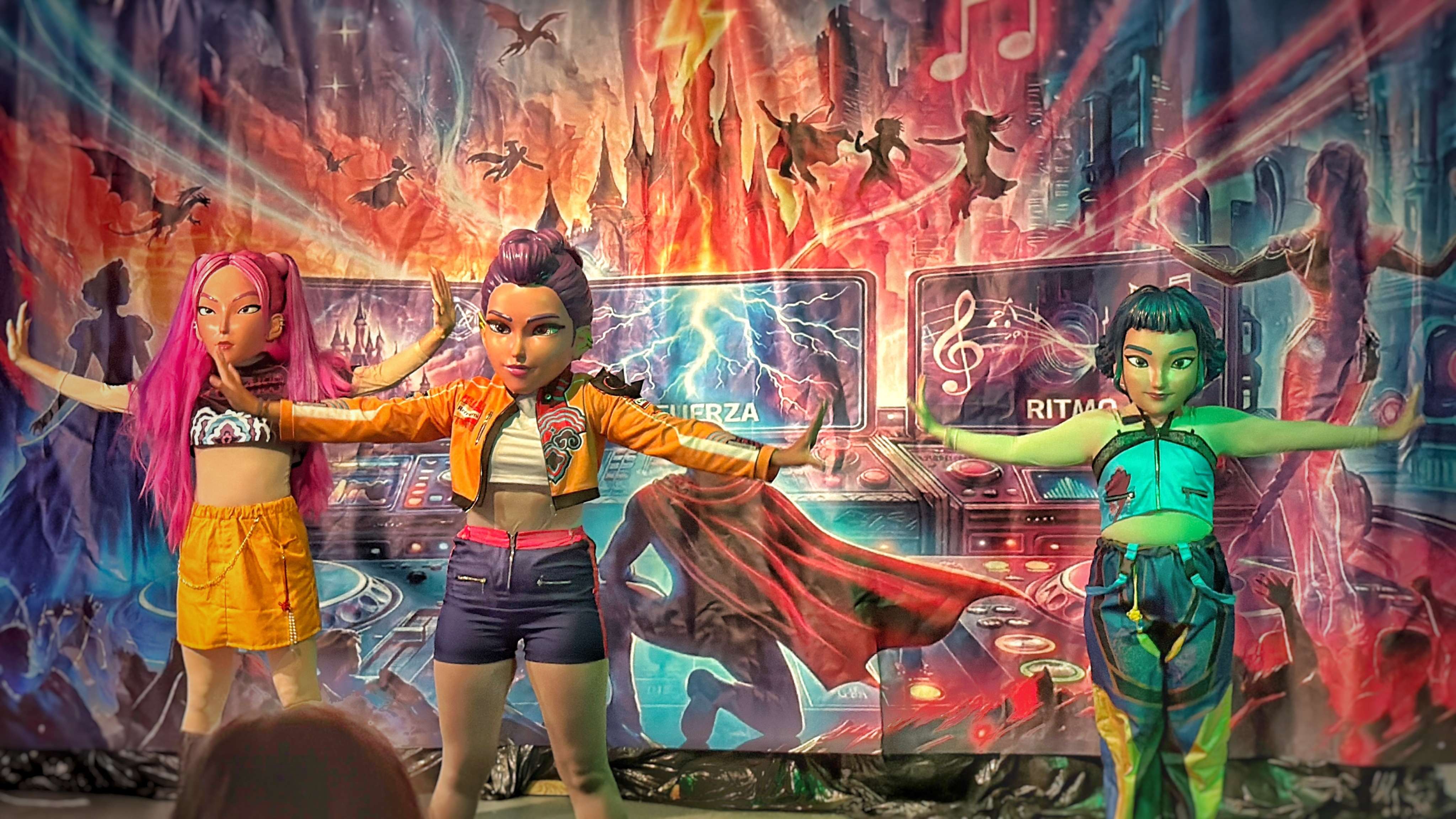 Tres personajes con máscaras de guerreras Pop en la parte de ritmo del espectáculo Sincronía en Peñíscola